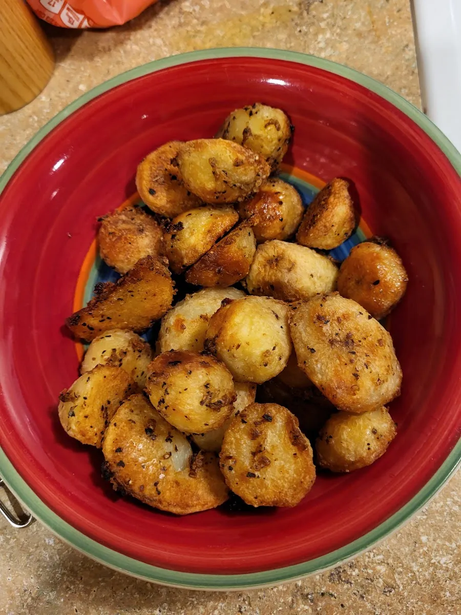 Crisp roast potatoes with herbs — illustrative photograph