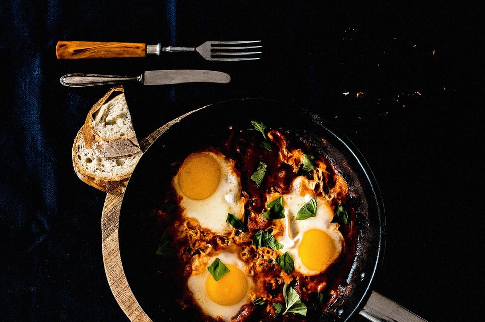 Eggs in a smoky tomato pan — illustrative photograph